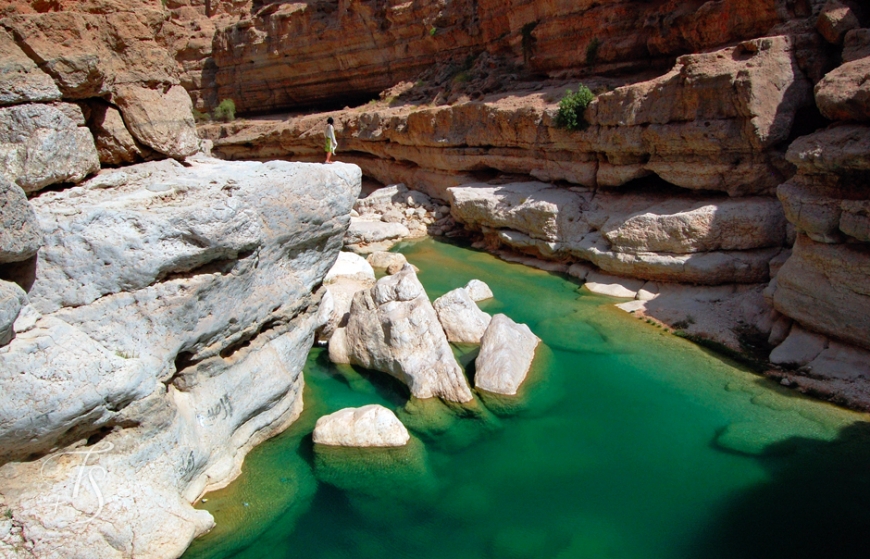 Boulders the size of houses in Wadi Shab, Oman. © Travel+Style