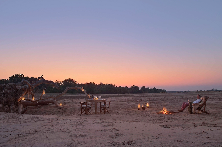 Sundowners in the riverbed. Chinzombo Camp, Zambia. travelplusstyle.com