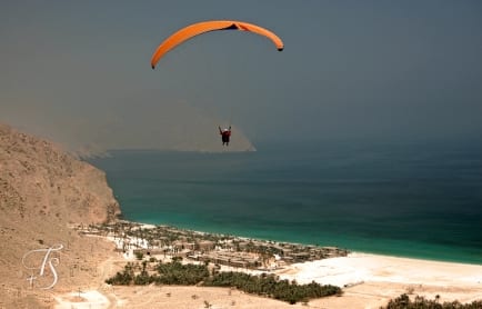 Paragliding above Zighy Bay, Oman. © Travel+Style