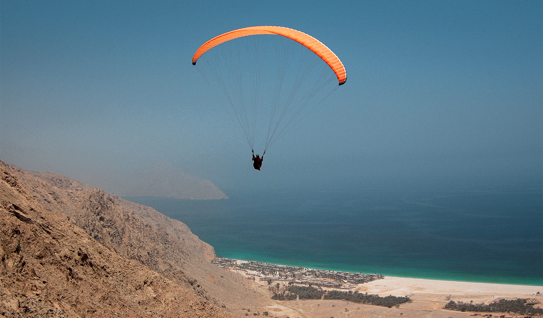 Paragliding in Zighy Bay. The Top 10 Things To Do in Oman. Photo by © TravelPlusStyle.com