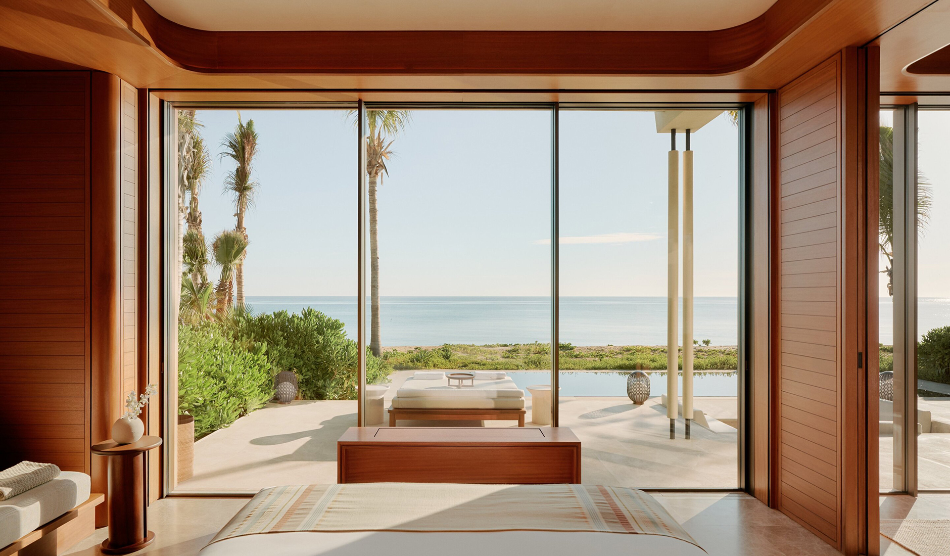 Interior of a luxury pavilion suite at Amanvari resort in Mexico, featuring floor-to-ceiling windows, natural wood design, and a private plunge pool.