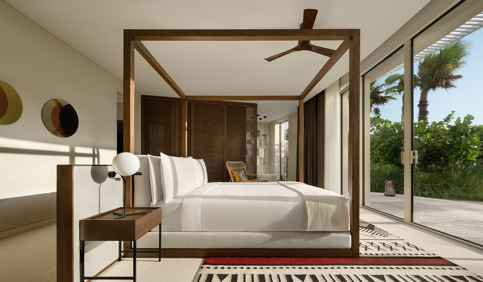 Glamorous contemporary bedroom interior of a luxury suite at SLS The Red Sea, blending maximalist coastal chic design with high-end furnishings.