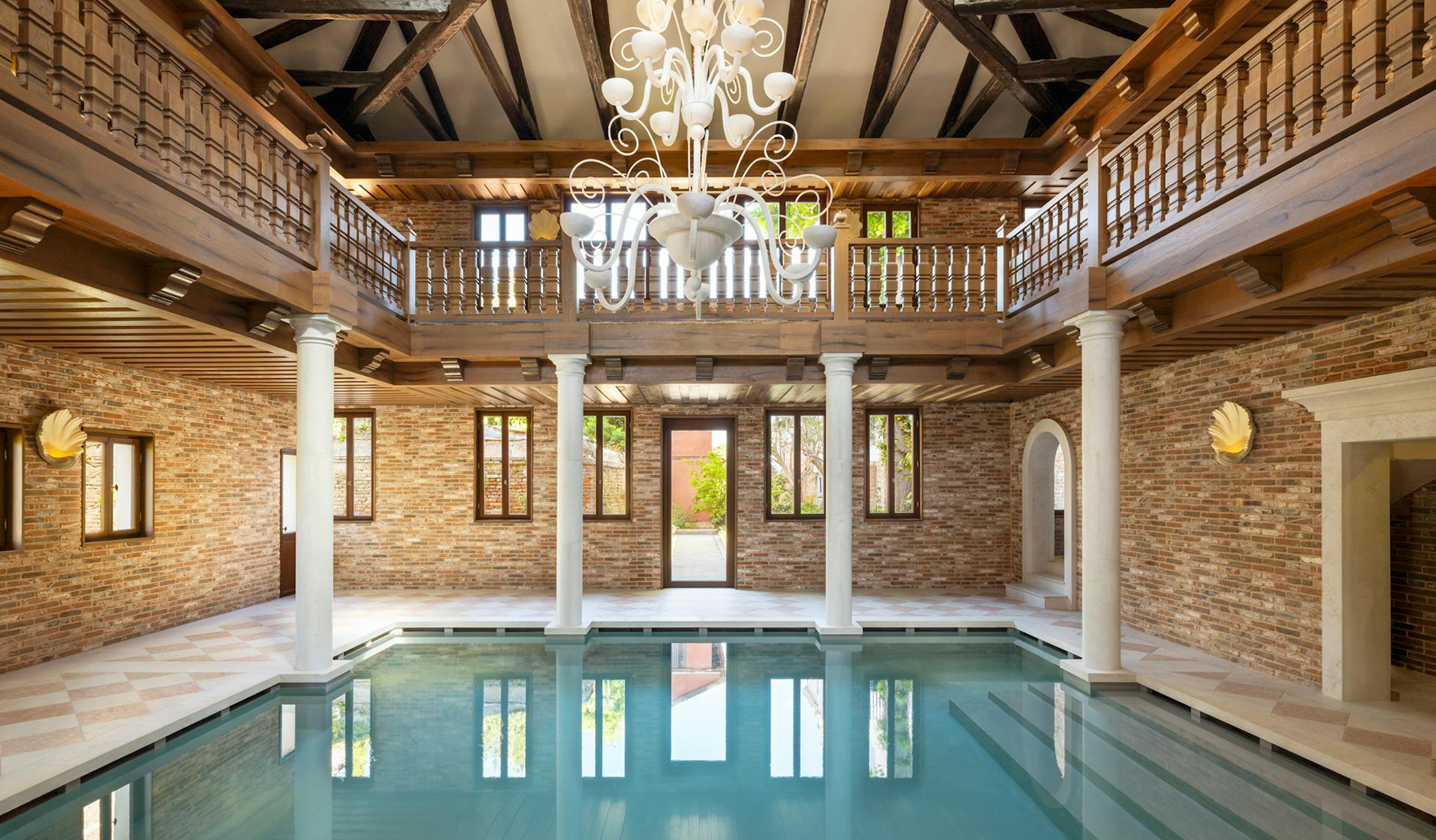 Interior of the indoor swimming pool at Airelles Palladio Venezia with architectural details inspired by classical design
