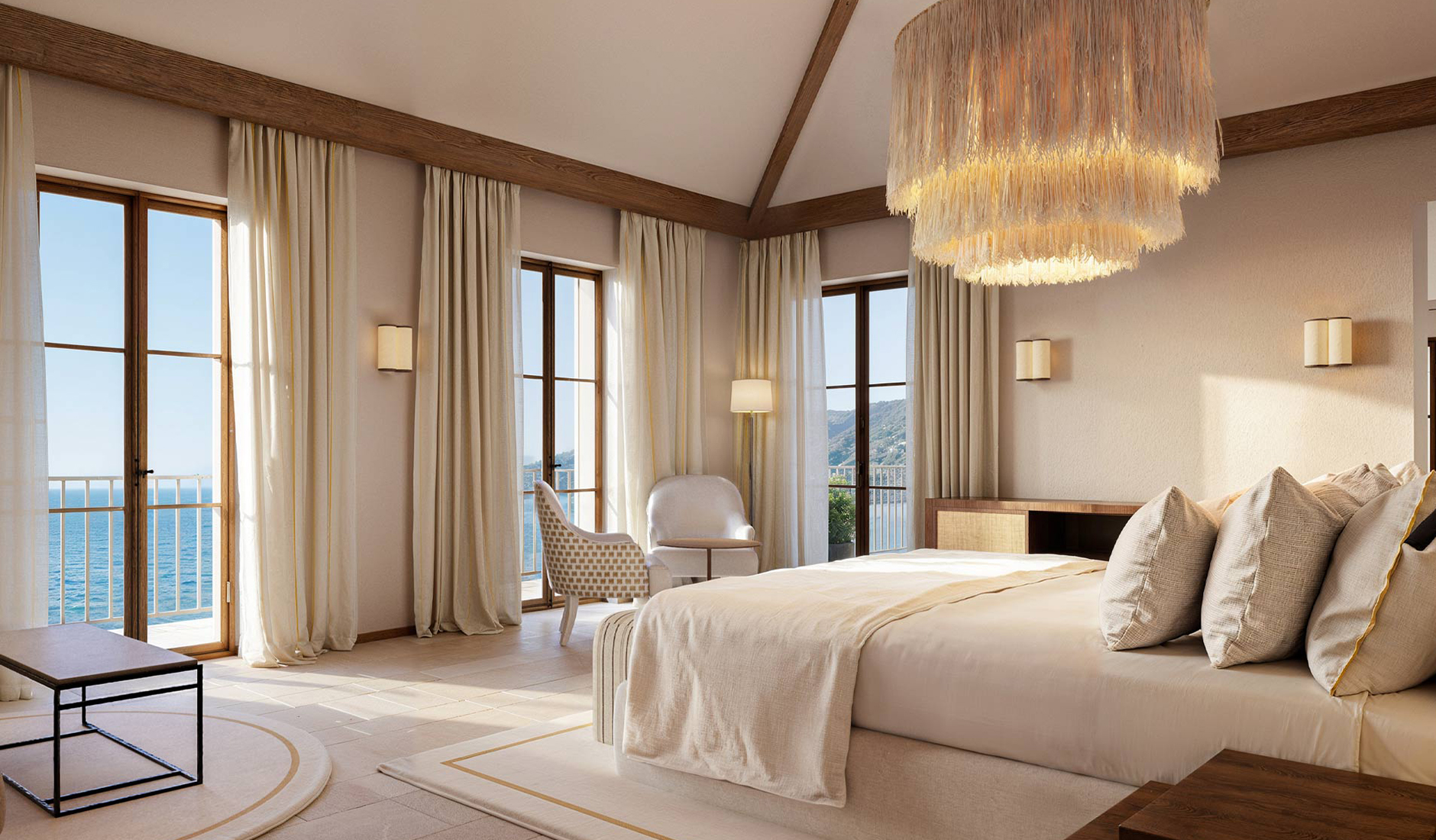 Double room at Gran Hotel Margalida with a king-size bed, natural finishes and a balcony overlooking the sea