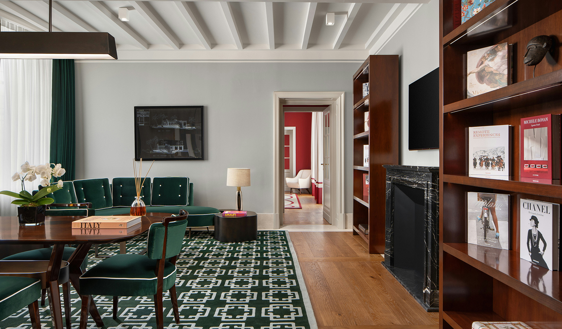 Lounge at Casa J.K. Place Roma with built-in bookshelves and comfortable seating