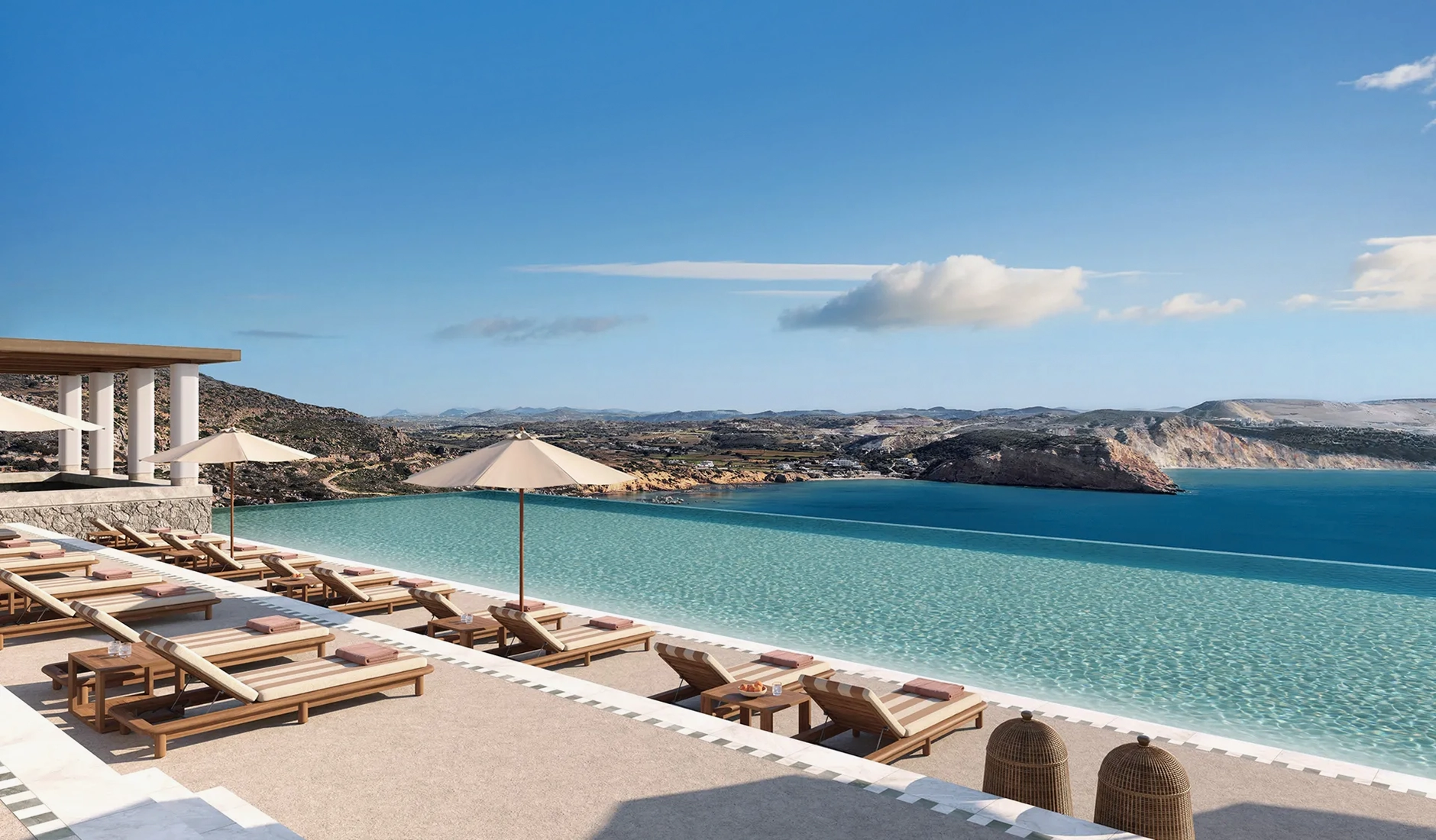 Spectacular view of the main outdoor swimming pool at Eréma hotel in Milos, showcasing minimalist natural stone design and panoramic views of the Aegean Sea.