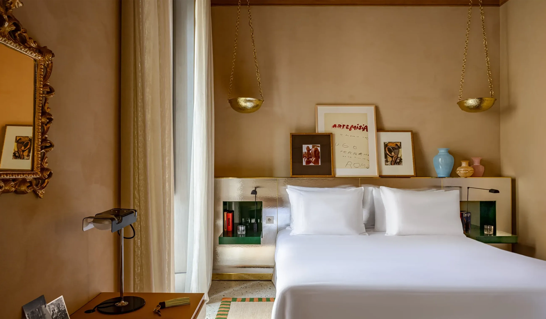 Bedroom at Experimental Roma featuring a crisp white bed and modern artwork