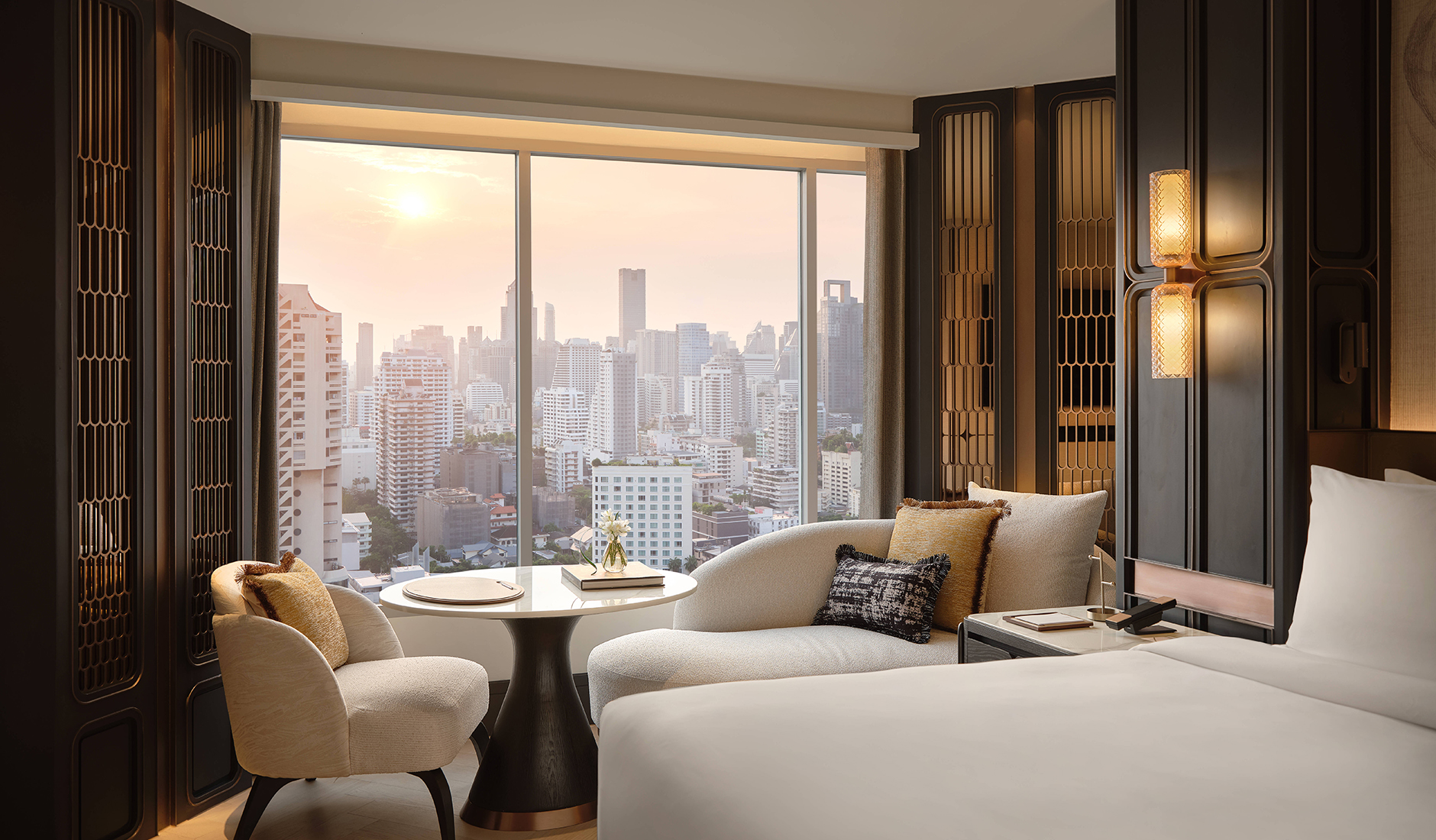 Bangkok skyline viewed through the floor-to-ceiling windows of a Fairmont Bangkok Sukhumvit guest room