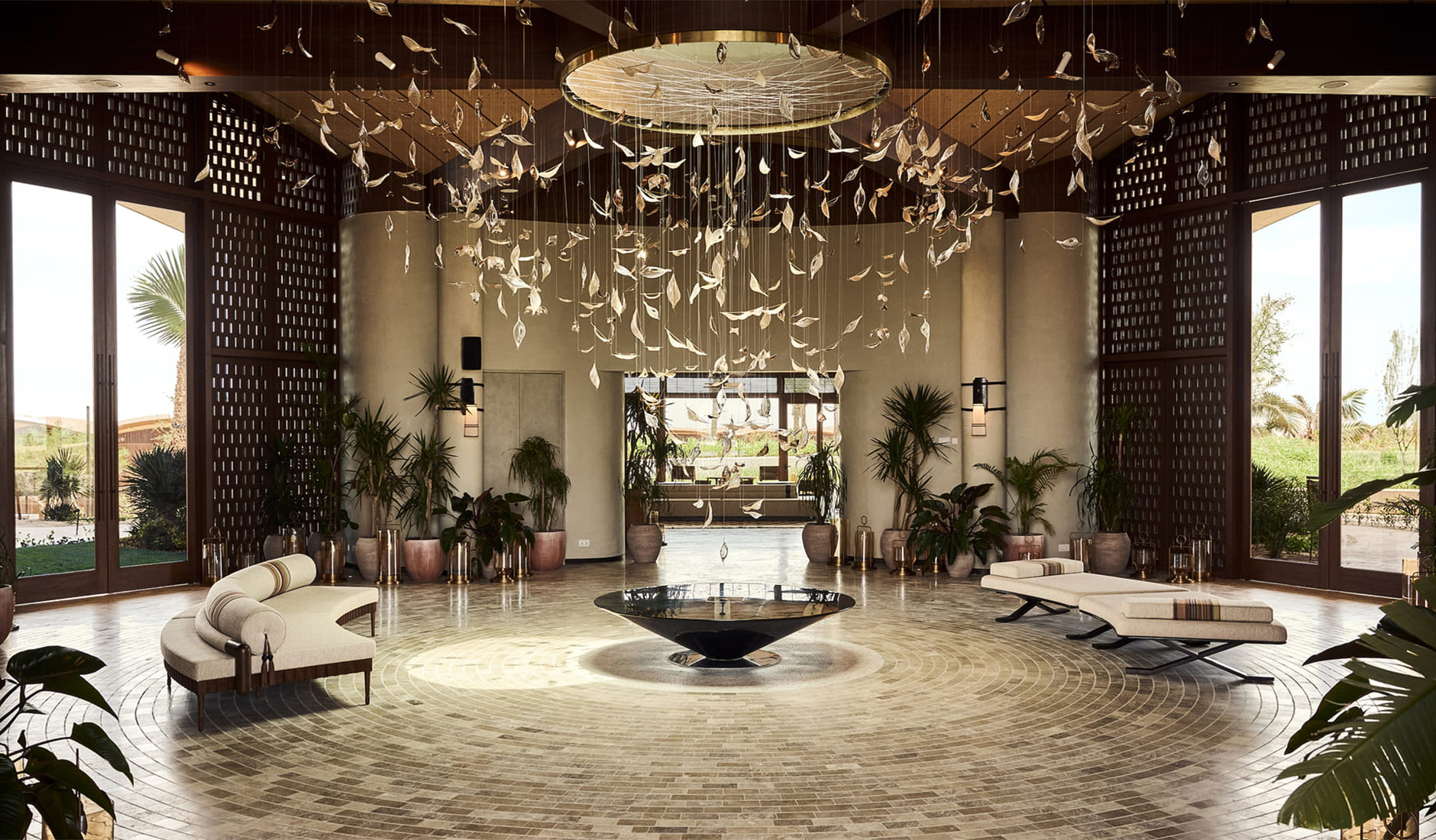 Grand and opulent interior of the lobby lounge at Four Seasons Resort and Residences Red Sea at Shura Island, featuring soaring ceilings, contemporary Arabian-inspired decor, and bespoke luxury design installations.