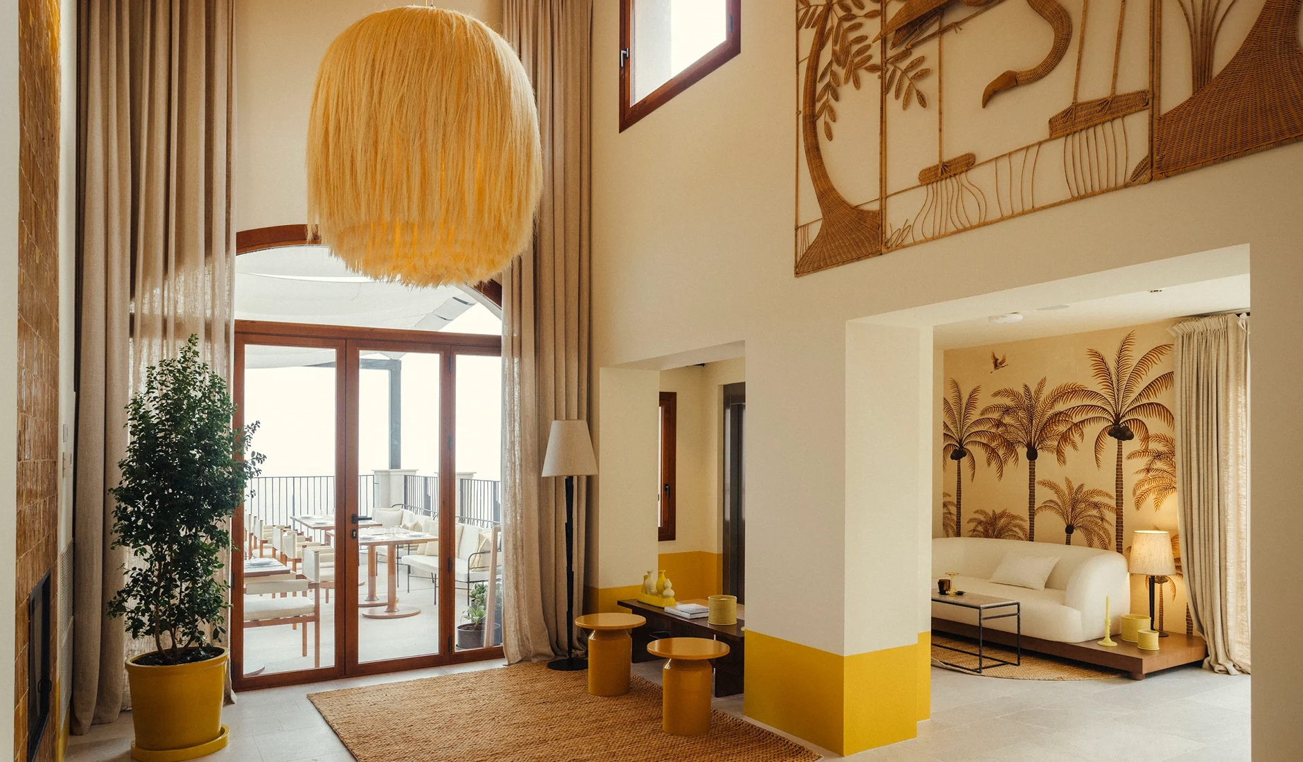 Double-height lobby at Gran Hotel Margalida with sculptural details, natural textures and views towards the sea