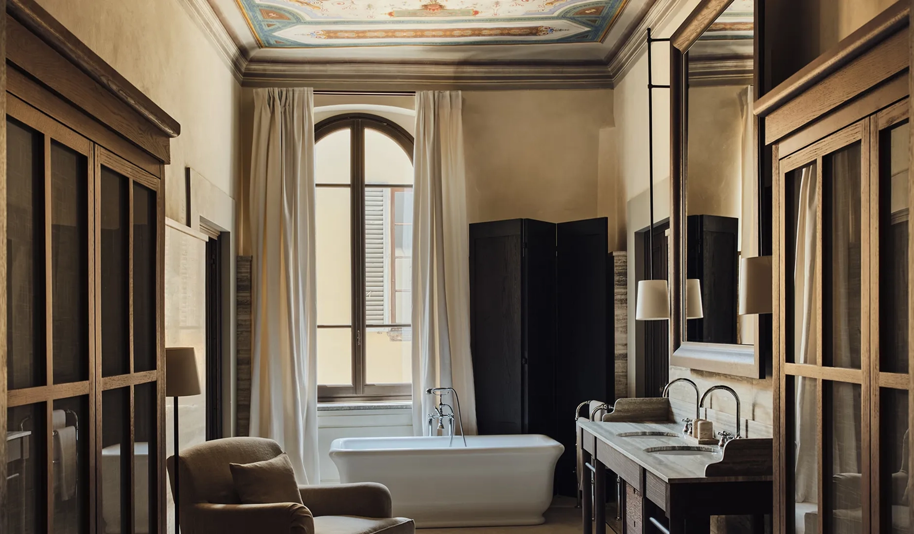 Bathroom finished in travertine stone inside a private residence at La Réserve Firenze