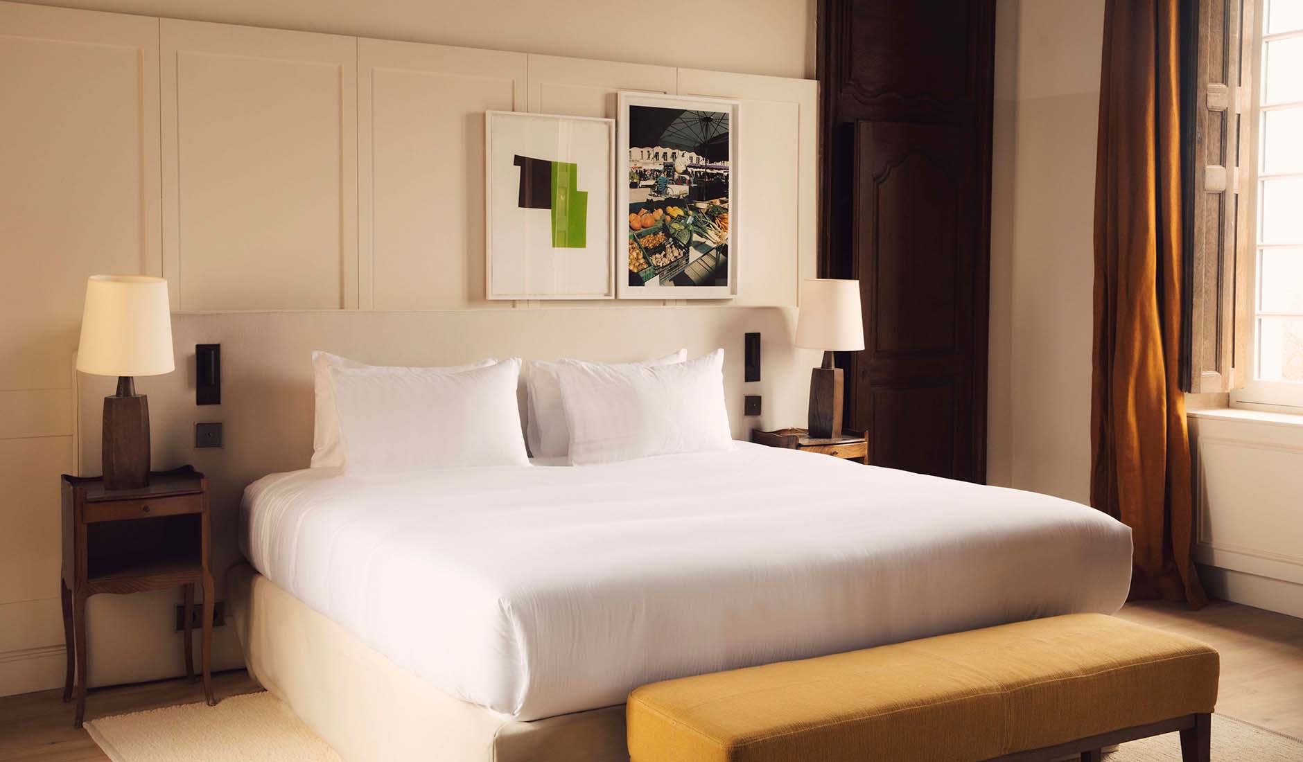 Guest room at Les Sources de Vougeot with understated furnishings and Burgundy-inspired colours