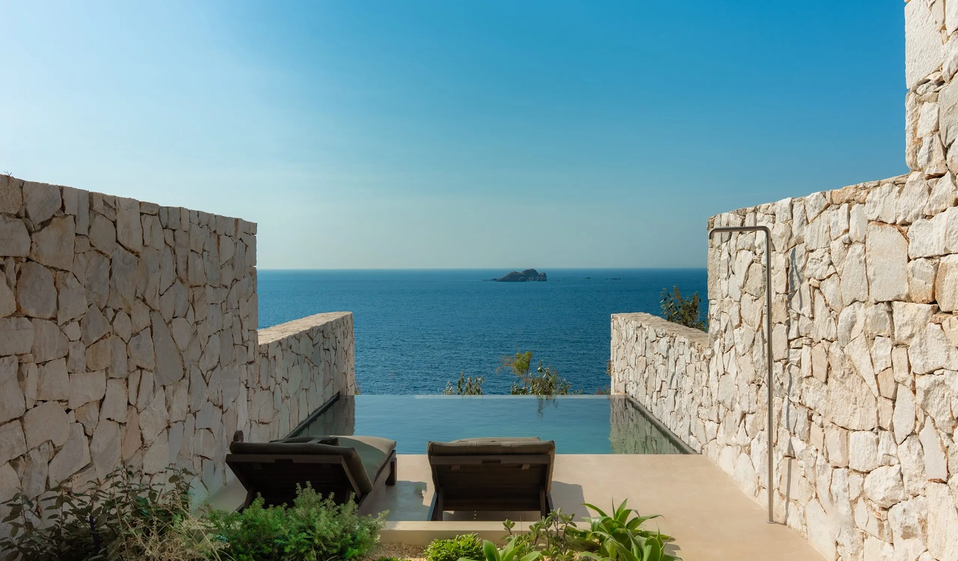 Private pool framed by pale stone and white walls at Luura Cliff