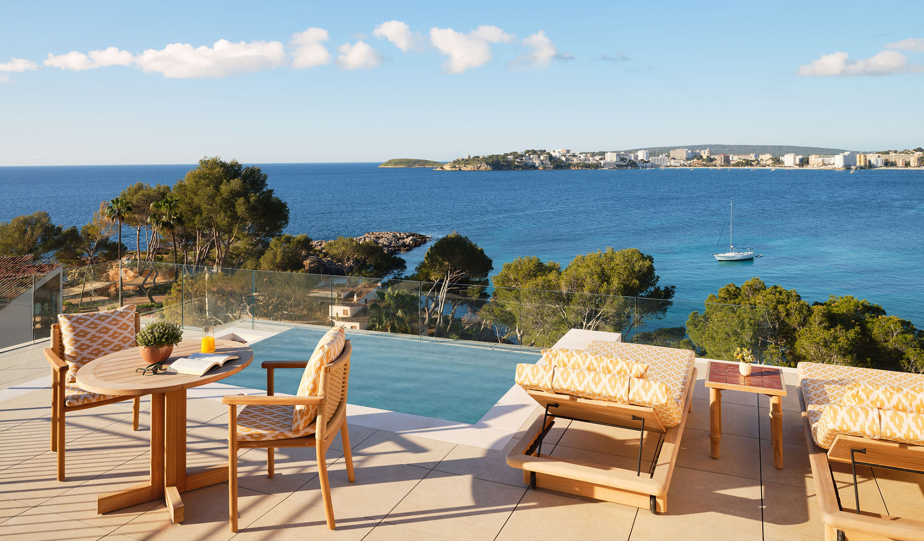 Breathtaking aerial view of the Mandarin Oriental Punta Negra resort in Mallorca, nestled on a pine-covered peninsula surrounded by the Mediterranean Sea.