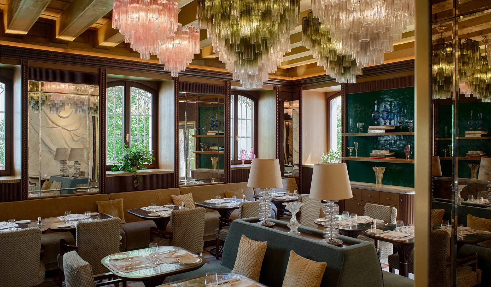 Sophisticated dining room at the exclusive Orient Express hotel restaurant in Venice, beautifully set for dinner with fine crystal and luxury decor.