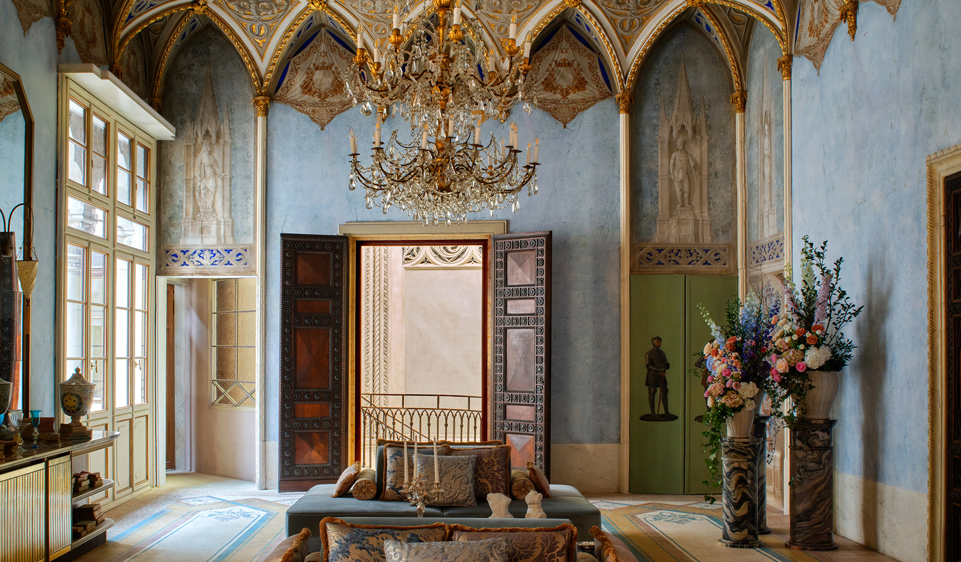 A grand lounge area inside the Orient Express hotel in Venice, showcasing high-end Italian furniture, dramatic lighting, and historic Venetian architectural details.