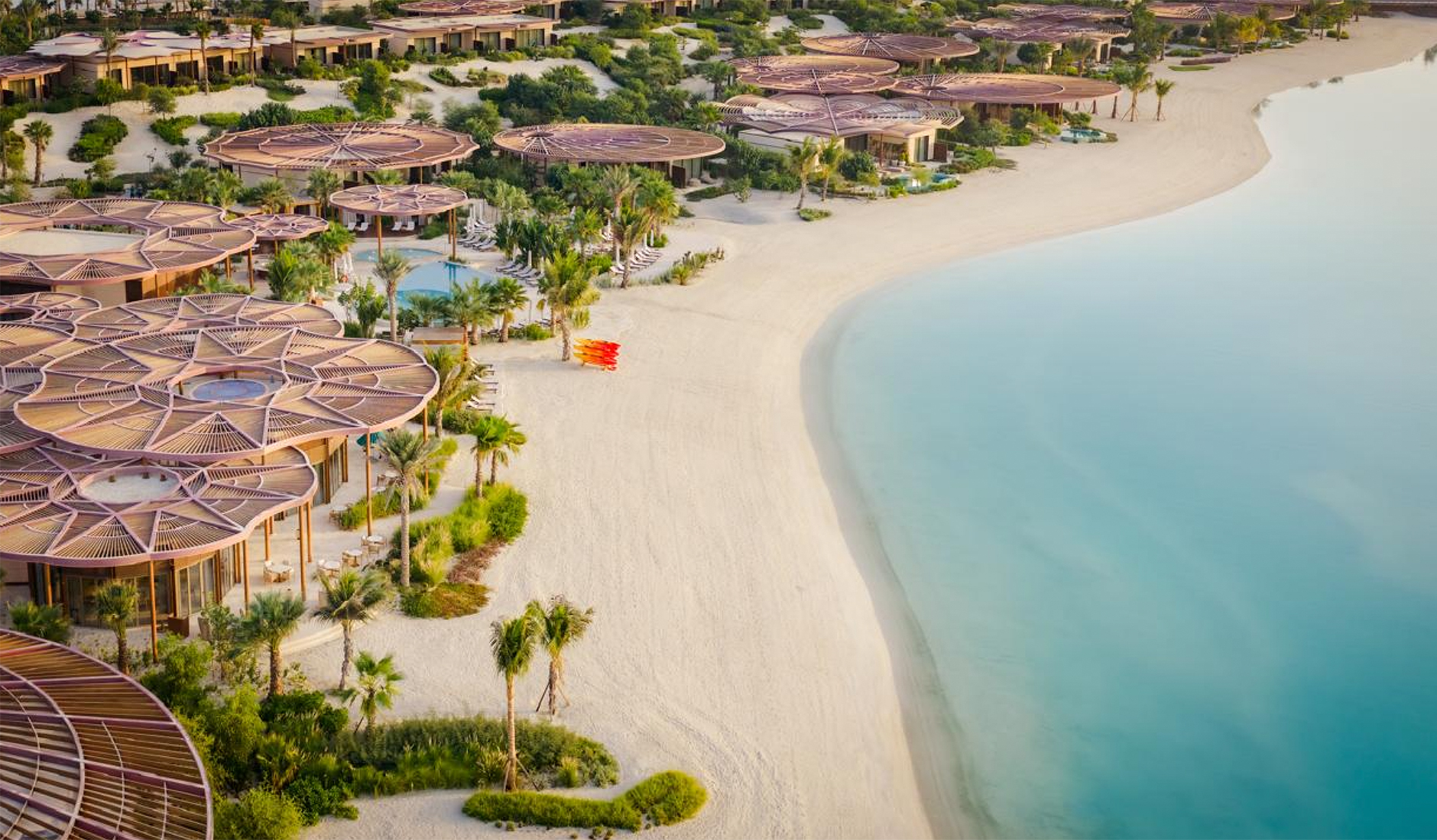 Stunning aerial view of Raffles The Red Sea resort on Shura Island, showcasing its unique dune-inspired organic architecture along the Saudi Arabian coastline.