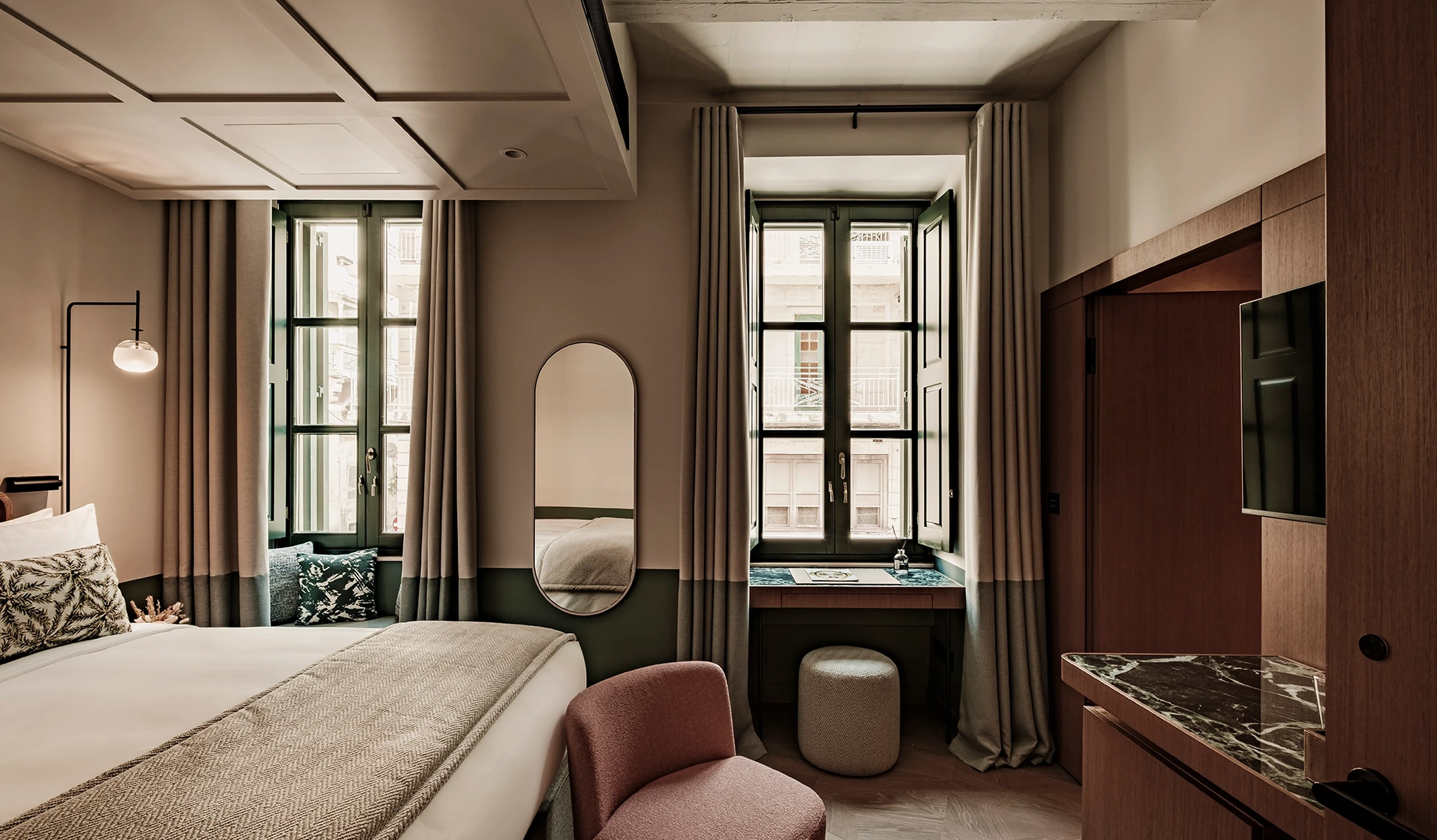 Sophisticated five-star bedroom interior inside Romègas Hotel, blending historic architectural details with bespoke contemporary Maltese artwork and terrazzo flooring.