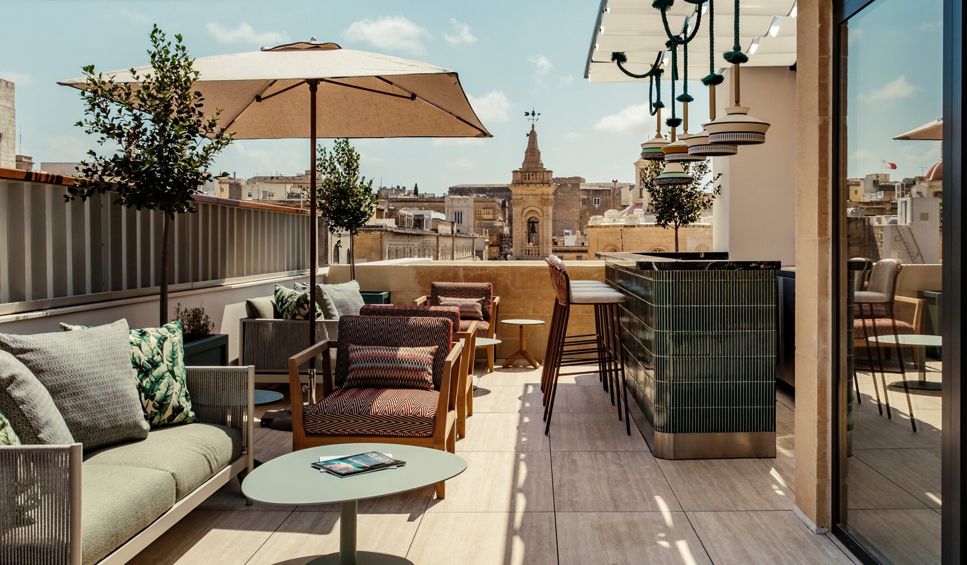 Breathtaking outside rooftop bar at Romègas, ranked among the best luxury hotels in Malta, offering an exclusive open-air lounge experience with historic Valletta skyline views.