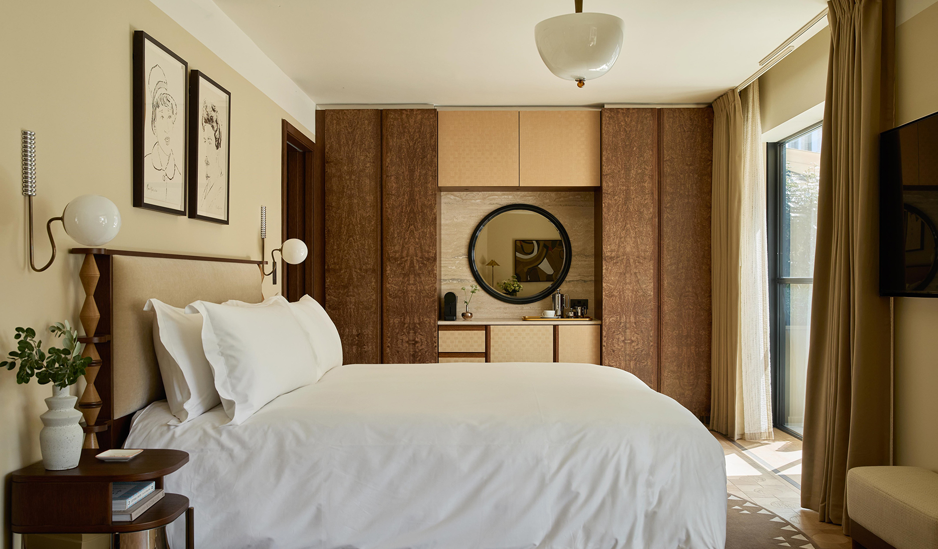 King bedroom at The Newman with layered bedding and a warm, understated colour palette