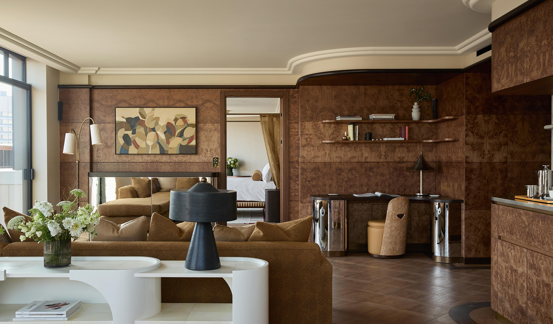 Sitting area in a suite at The Newman with comfortable upholstery and warm wood accents