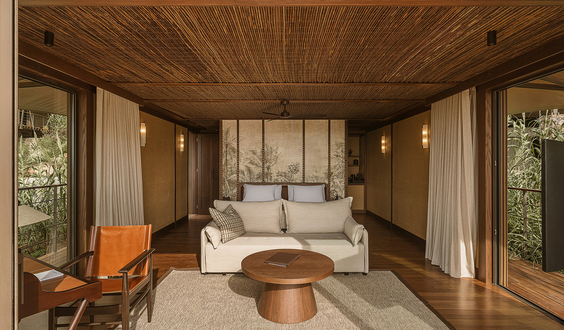 Interior of a luxury tented pavilion at The Revery Wild combining canvas architecture with contemporary comforts