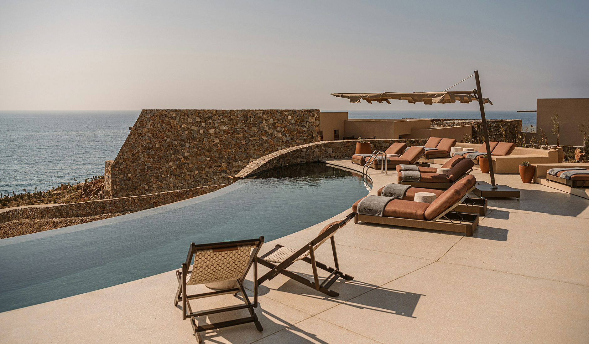 Clifftop swimming pool at The Revery with panoramic views across the Libyan Sea