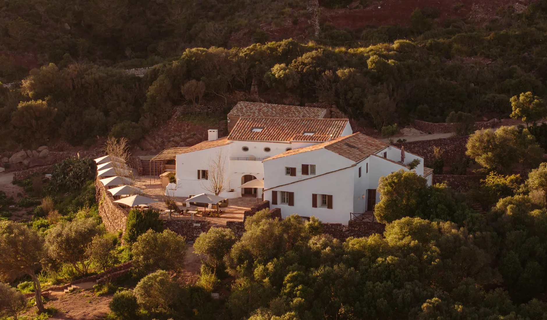 Beautiful historic facade of Vestige Binidufà, ranked among the best luxury hotels in Menorca, showcasing beautifully restored 19th-century architecture surrounded by nature.
